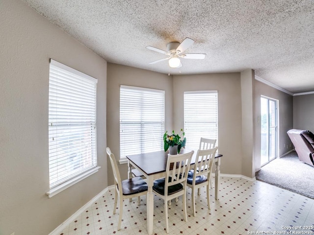 dining area featuring baseboards, a ceiling fan, light floors, and a wealth of natural light