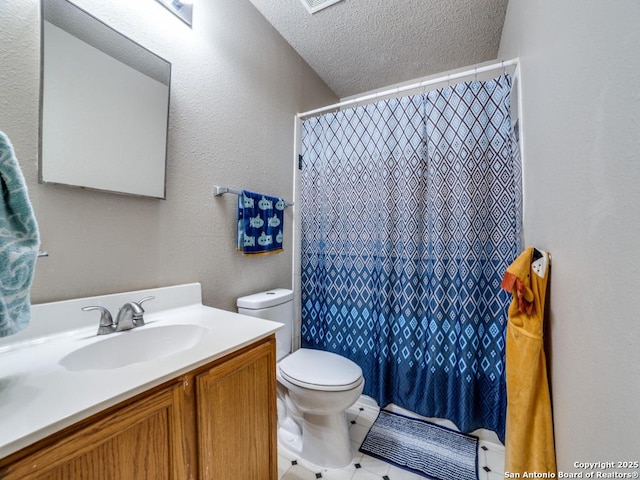 bathroom featuring vanity, a textured ceiling, a shower with shower curtain, and toilet