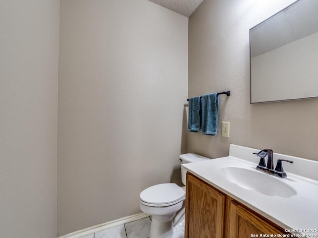 bathroom featuring vanity, tile patterned floors, and toilet