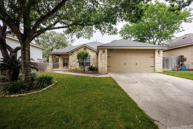 ranch-style home featuring a front yard, a garage, fence, concrete driveway, and stone siding
