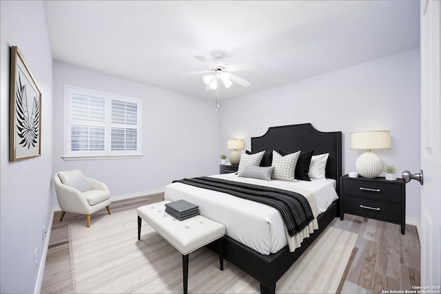 bedroom with baseboards, a ceiling fan, and light wood finished floors