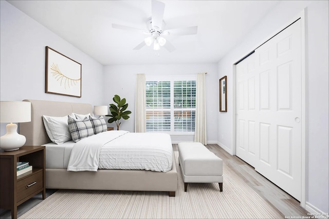 bedroom featuring a closet, baseboards, ceiling fan, and light wood-type flooring