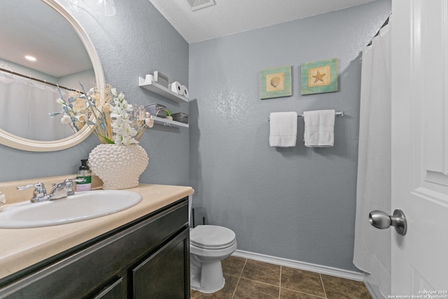 full bath with baseboards, vanity, and toilet