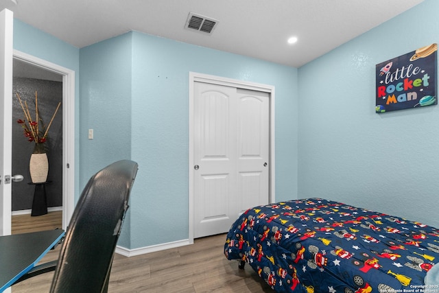 bedroom featuring visible vents, wood finished floors, baseboards, a closet, and recessed lighting