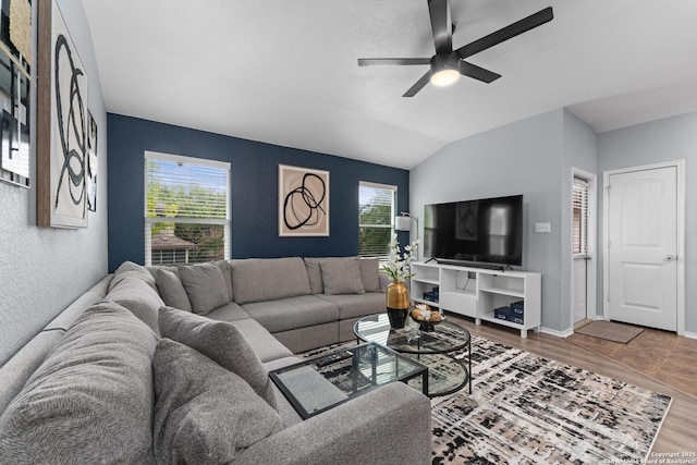 living room with a ceiling fan, baseboards, a healthy amount of sunlight, and wood finished floors