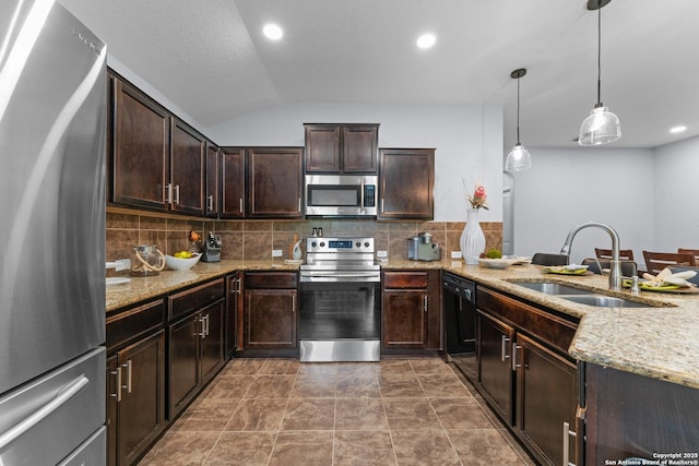 kitchen featuring dark brown cabinetry, tasteful backsplash, a sink, light stone counters, and stainless steel appliances