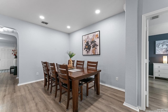 dining area featuring baseboards, recessed lighting, wood finished floors, and visible vents