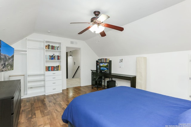 bedroom featuring a ceiling fan, lofted ceiling, dark wood-style flooring, and visible vents