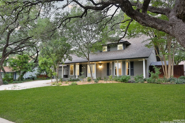 view of front of home with a front lawn, fence, a shingled roof, concrete driveway, and an attached garage