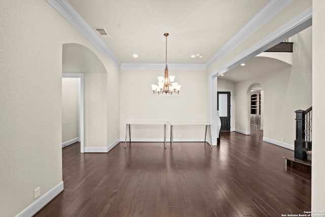 unfurnished dining area featuring dark wood-style flooring, arched walkways, visible vents, and a chandelier