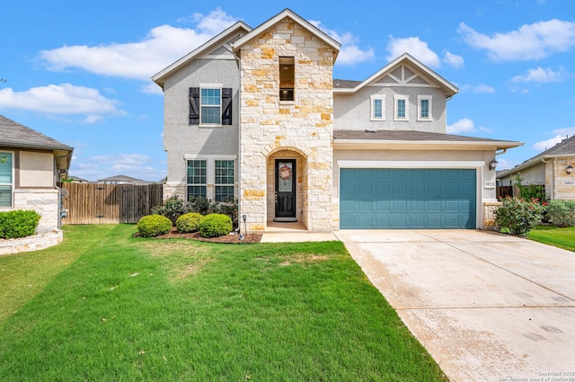 traditional-style house featuring a front lawn, fence, stone siding, an attached garage, and driveway