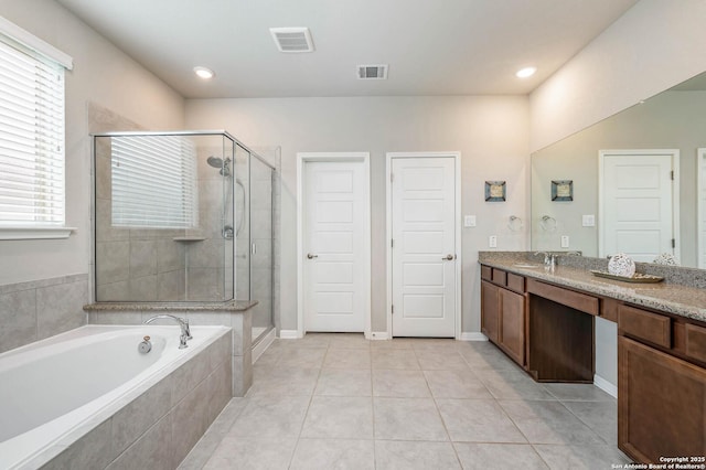 full bathroom with vanity, a garden tub, a stall shower, and visible vents