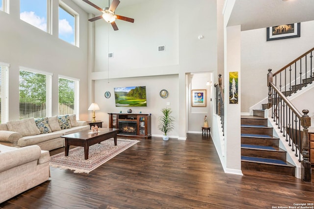 living room featuring a ceiling fan, wood finished floors, and visible vents