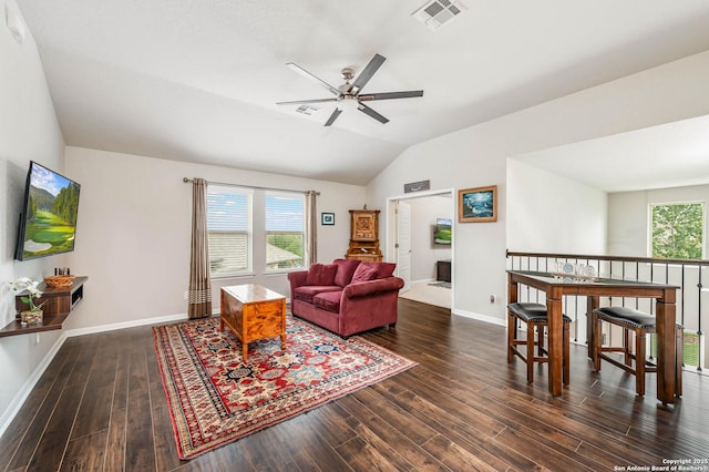 living room with ceiling fan, lofted ceiling, wood finished floors, and visible vents
