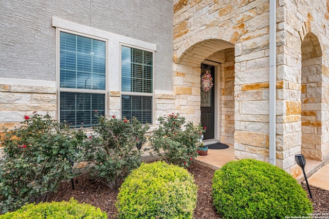 view of exterior entry featuring stone siding