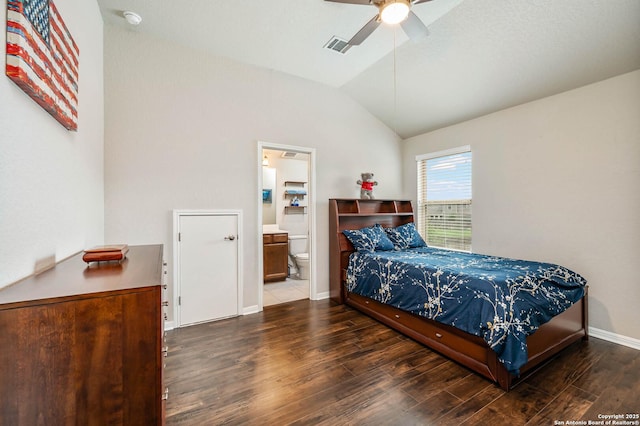 bedroom with a ceiling fan, baseboards, ensuite bathroom, wood finished floors, and lofted ceiling