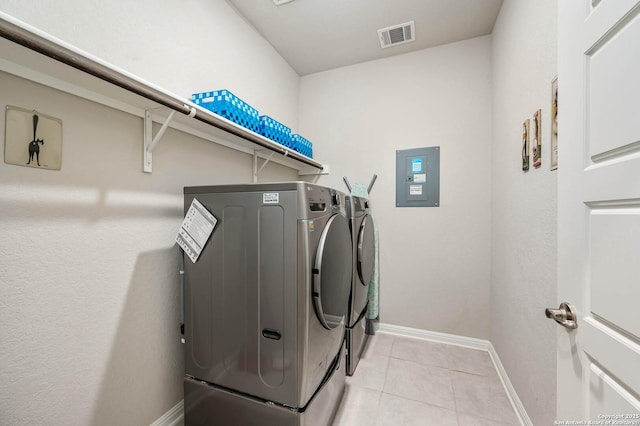 laundry room with laundry area, visible vents, light tile patterned floors, baseboards, and separate washer and dryer