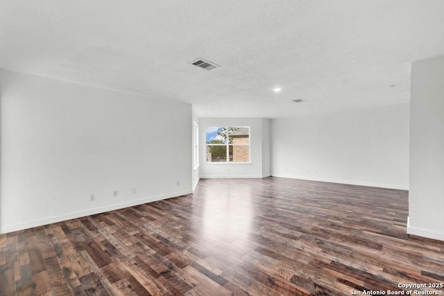 11202 Forest Pass, Live Oak, TX 78233 - unfurnished room with baseboards, dark wood-type flooring, recessed lighting, and visible vents