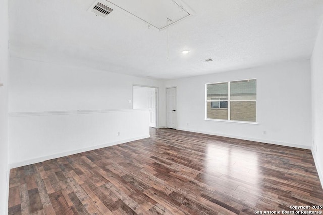 11202 Forest Pass, Live Oak, TX 78233 - spare room with baseboards, attic access, wood finished floors, and visible vents