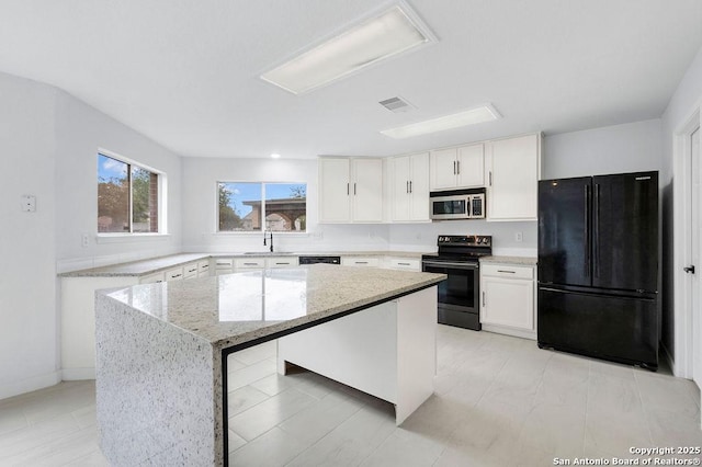 11202 Forest Pass, Live Oak, TX 78233 - kitchen featuring light stone counters, a sink, a center island, stainless steel appliances, and visible vents