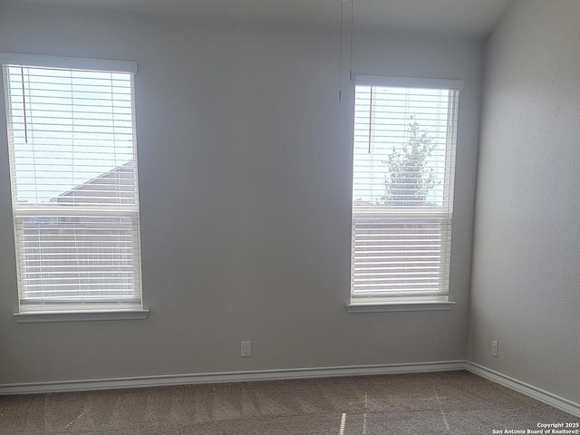 empty room with baseboards and carpet flooring
