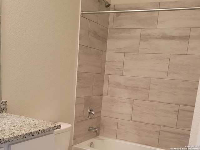 full bath with toilet, a textured wall, bathing tub / shower combination, and vanity