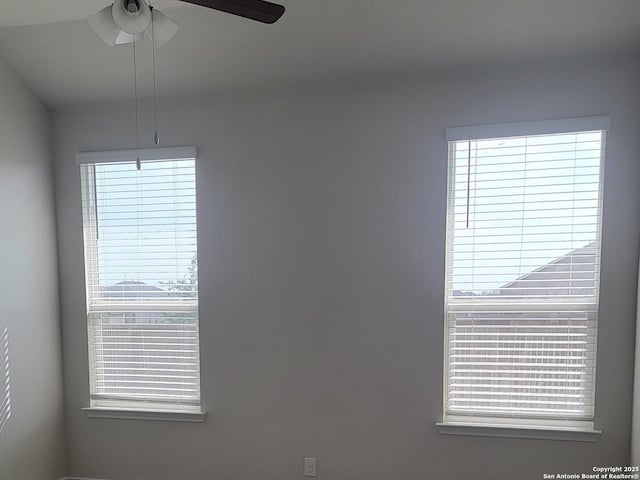 unfurnished room with ceiling fan and plenty of natural light
