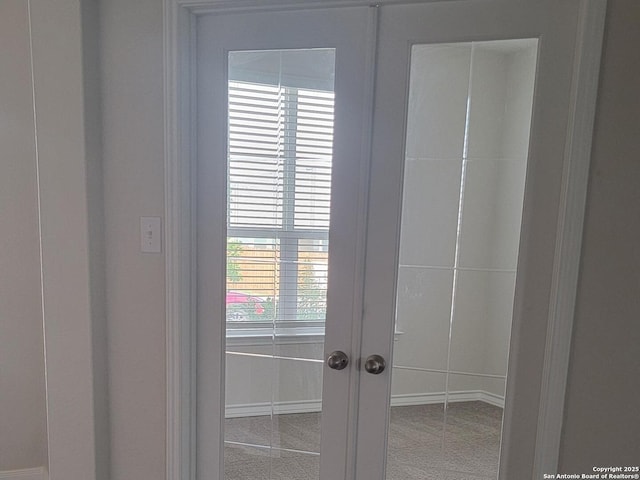 details with baseboards, carpet, and french doors