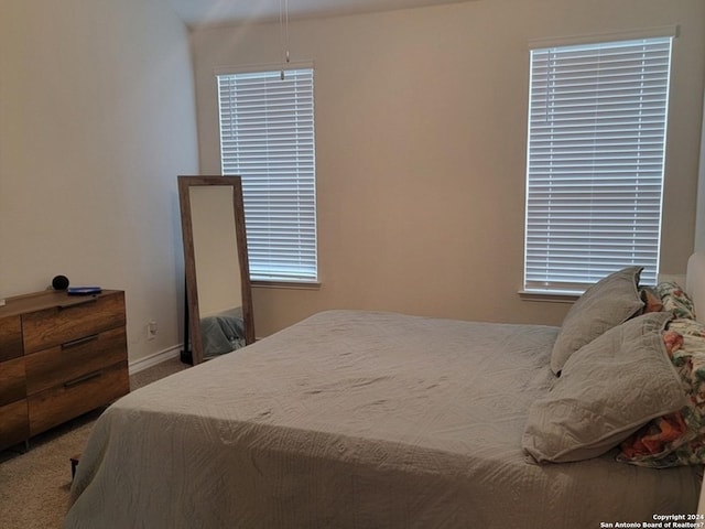 carpeted bedroom featuring baseboards