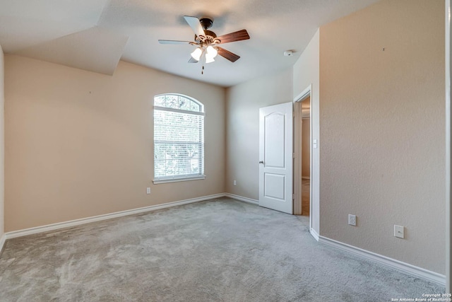 unfurnished room featuring carpet floors, a ceiling fan, and baseboards