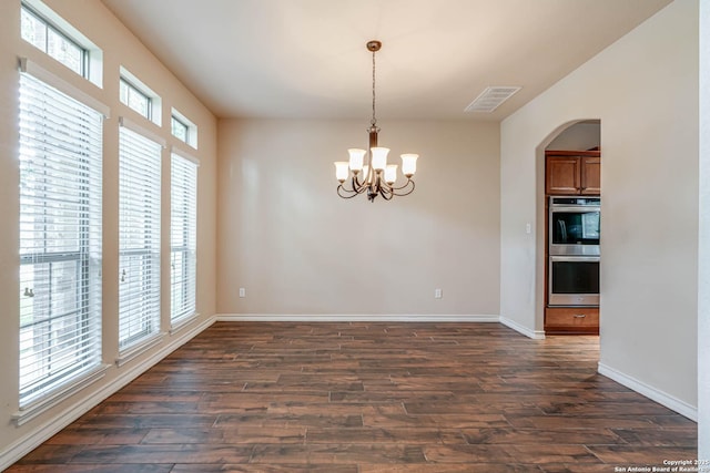 unfurnished dining area featuring visible vents, dark wood-style flooring, baseboards, and a chandelier