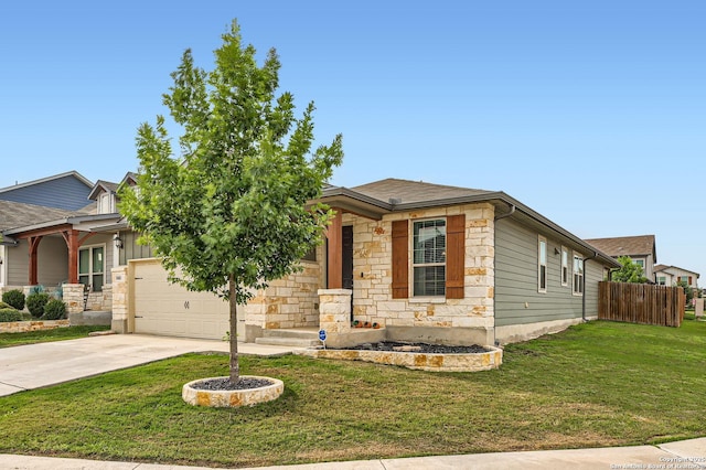 view of front of house featuring driveway, a front yard, fence, an attached garage, and stone siding