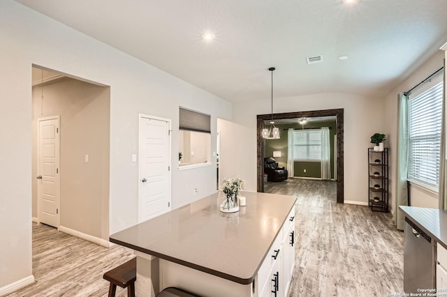 dining room with visible vents, light wood-style floors, plenty of natural light, and baseboards