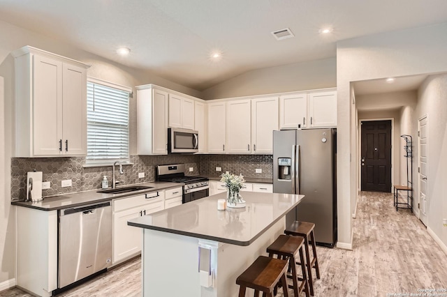 kitchen featuring a sink, white cabinetry, and stainless steel appliances