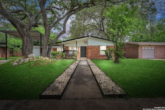 mid-century modern home featuring a garage, a front yard, and brick siding