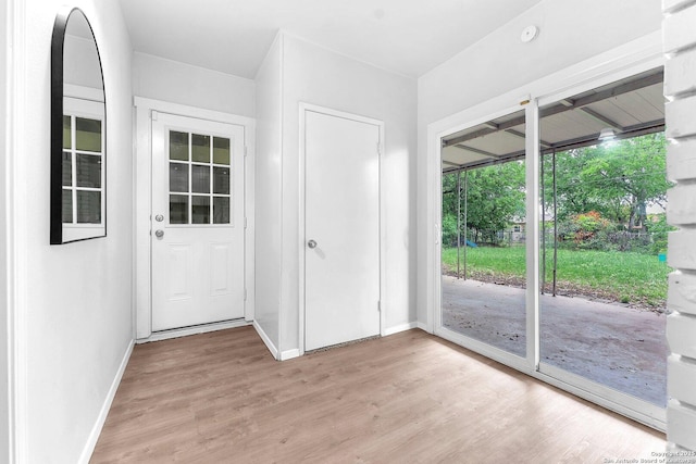 entryway with light wood-style floors and baseboards
