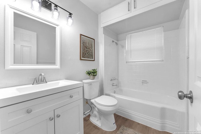 full bathroom with vanity, toilet, wood finished floors, and shower / washtub combination