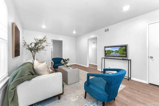 living area with visible vents, recessed lighting, baseboards, and wood finished floors