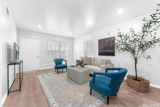 living room featuring baseboards, recessed lighting, wood finished floors, and visible vents