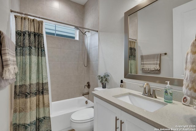 full bathroom with vanity, shower / bath combo, and toilet