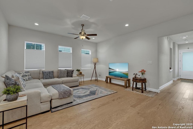 living area featuring baseboards, a ceiling fan, wood finished floors, and recessed lighting