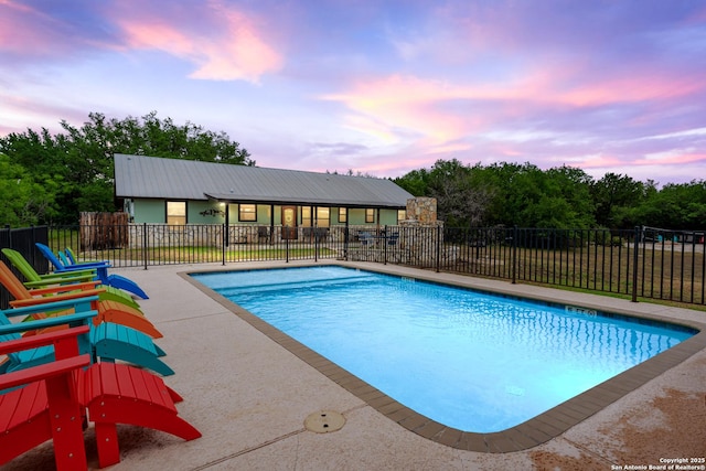 view of swimming pool with fence, a fenced in pool, and a patio area