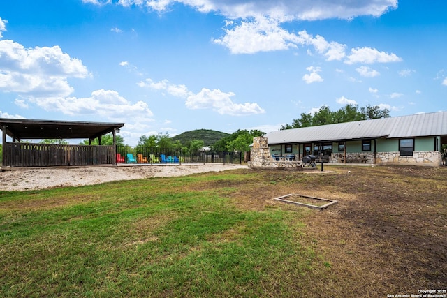 view of yard featuring fence and a mountain view