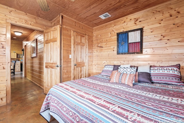 bedroom featuring wood ceiling, wood walls, finished concrete floors, and visible vents