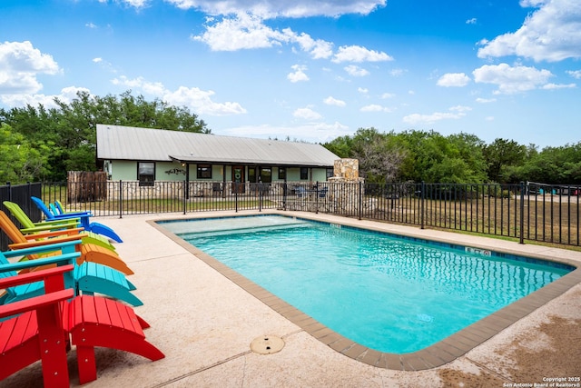 view of swimming pool featuring fence, a patio area, and a fenced in pool
