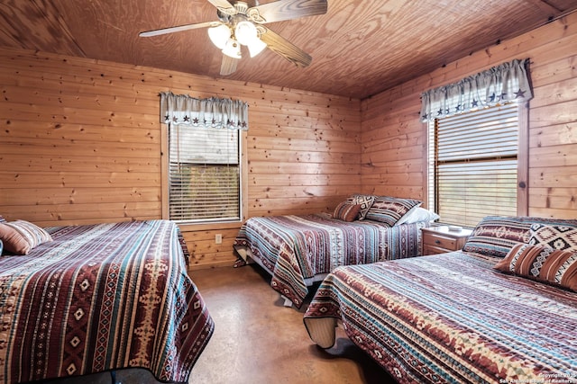 bedroom with concrete flooring, ceiling fan, wood walls, and wood ceiling