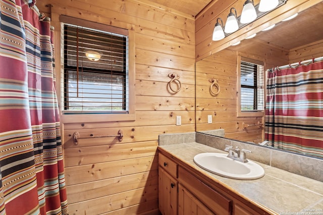 bathroom featuring vanity, wood walls, curtained shower, and wooden ceiling