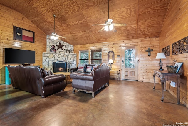 living area featuring finished concrete flooring, wooden ceiling, ceiling fan, and wood walls
