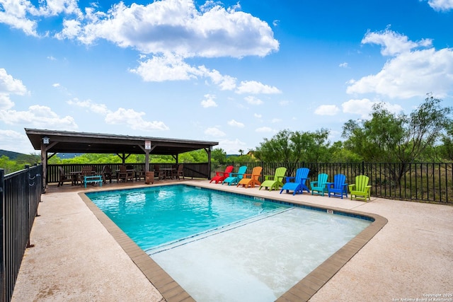 pool with a gazebo, fence, and a patio area
