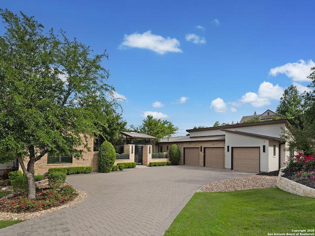 4701 Peralta Ln, Austin, TX 78735 - prairie-style house featuring a garage, stucco siding, driveway, and a front yard